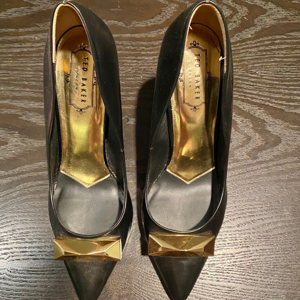 Black  heel pumps with gold heel.